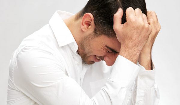 businessman portrait holding his head in white shirts hand gesture copy-space elegant style headache. High quality photo