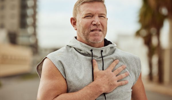 Face, fitness and man with heart attack in city after running, workout or training accident. Sports.