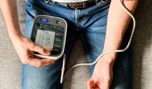 man-checking-blood-pressure-at-home-sitting-on-a-2024-12-07-19-39-26-utc